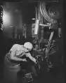 Emma Dougherty who does a man's work for a man's pay, cleaning out her end-grinding machine