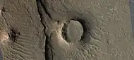 Eroded craters, as seen by HiRISE.  One crater is half eroded away.  Another crater has eroded to form a tall, thin rim.  And, its ejecta has been eroded away.  This image is part of an image that was named HiRISE picture of the day.