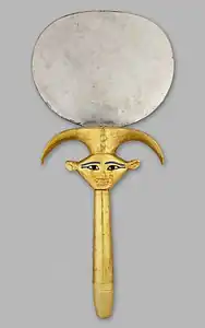 Ancient Egyptian mirror with a Hathor mascaron, c.1479–1425, disk: silver, handle: wood sheathed in gold with restored inlay, Metropolitan Museum of Art