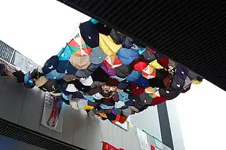 Umbrella art strung between two footbridges
