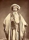 Arab man smoking pipe, late 1800s