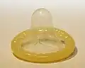 A rolled-up male condom.