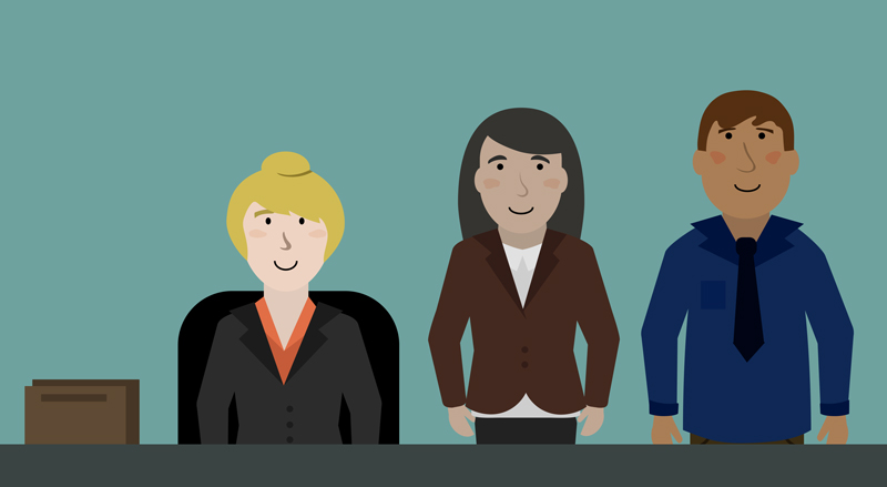 A trio of businesspeople smiling at work A trio of businesspeople smiling at work