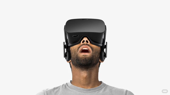 A man looks through a virtual reality headset. A man looks through a virtual reality headset.